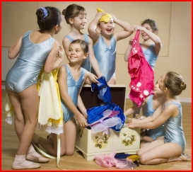 Photo of dancers looking for a costume in the dressing up box
